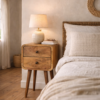 Solid mango wood bedside table with two drawers styled in a country cottage bedroom with exposed beams