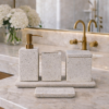 Terrazzo bathroom accessory set styled on a luxury vanity with gold fittings