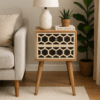 Mini bone inlay bedside table with two geometric drawers and Nordic legs, styled with a ceramic lamp, plant, sofa, and indoor greenery in a cozy modern room.