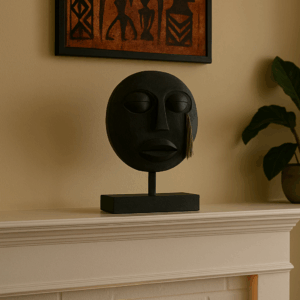 black tribal mask on fireplace