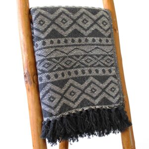 Measuring a generous 125 x 150 cm, this versatile throw brings a warm, inviting touch to any setting. Handcrafted in India from 100% cotton,