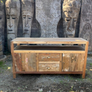 Reclaimed wood sideboard with open shelf, two drawers and two cabinet doors, photographed outdoors in front of carved wooden statues