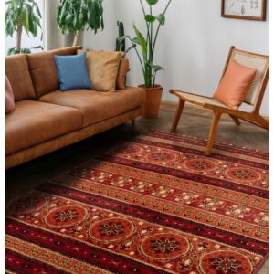 Apartment with bright living room in boho style. Interior design with brown couch, new armchair, decorative fireplace with candles, green house plants in clay pots and rug on the wooden floor