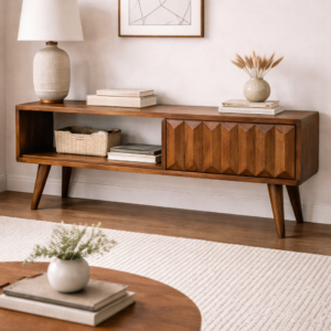 Mid-century mango wood media unit with geometric carved drawer, open shelving and tapered legs in a neutral living room