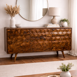 Solid mango wood sideboard with geometric carved doors and drawers, styled in a neutral living room with round mirror, lamp, and natural décor.