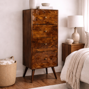Solid mango wood tall chest of drawers with geometric carved fronts, styled in a neutral bedroom with bedside table, lamp, and soft furnishings.