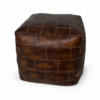 Brown patchwork leather pouffe with stitched panel design, isolated on a clean background for product display.